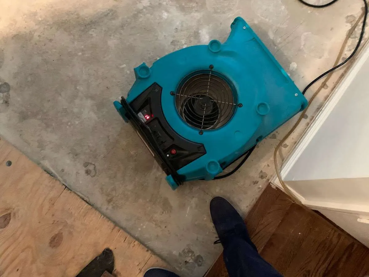 Air mover drying subfloor during Leak Detection & Repair in Boylston